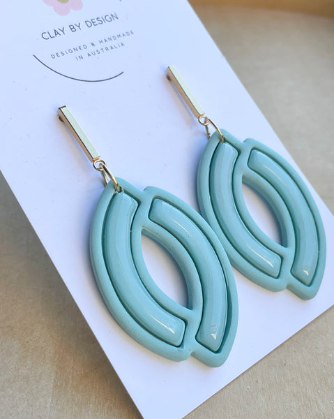 Soft mint blue curved dangles with glossy resin finsh