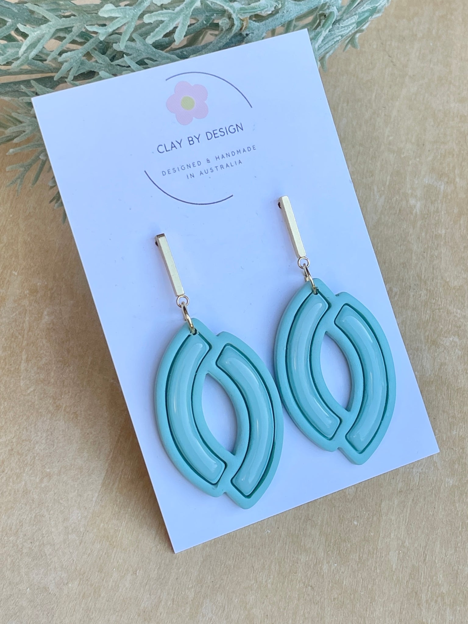 Soft mint blue curved dangles with glossy resin finsh